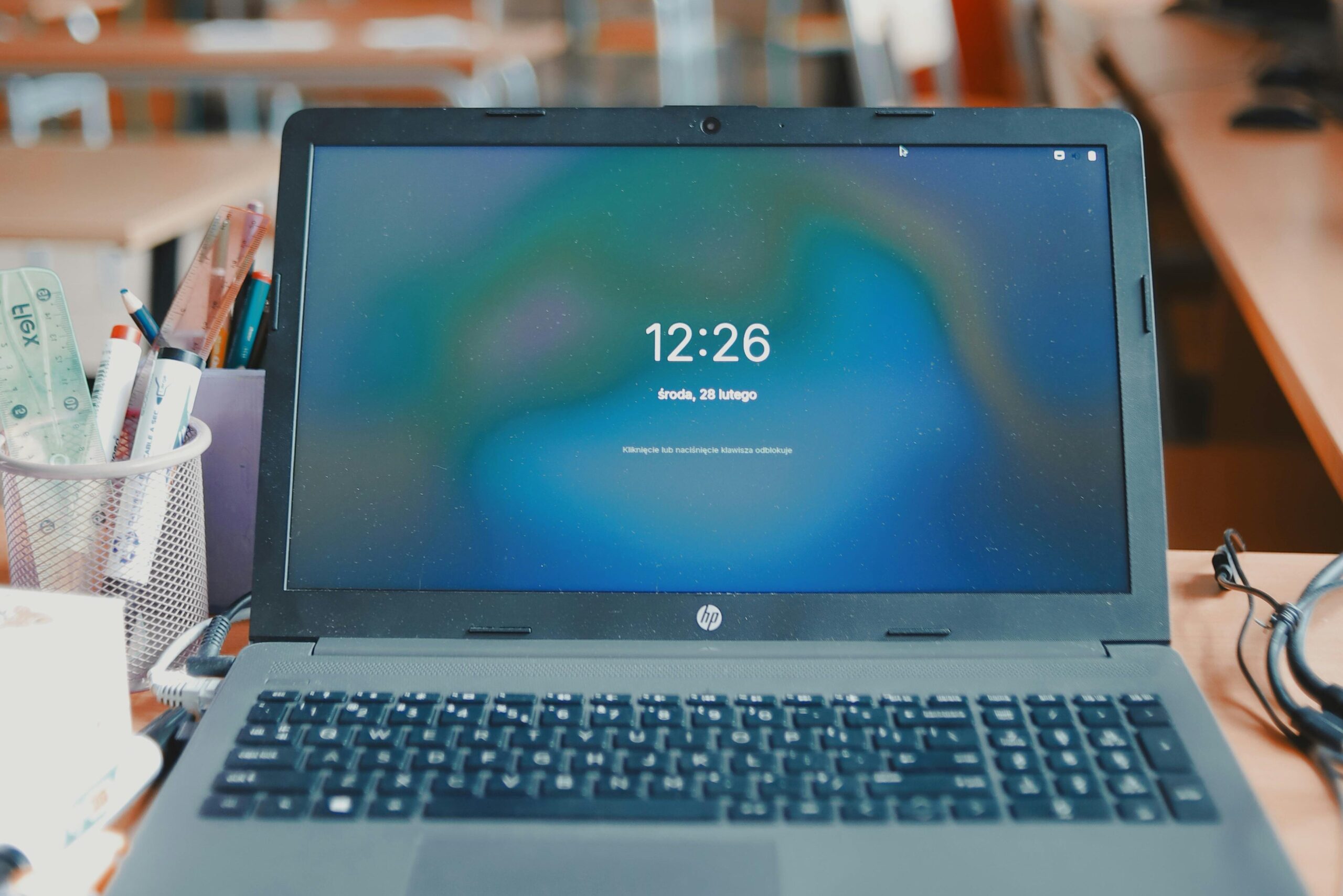 yoga A laptop sits on a desk in a classroom setup, showcasing a modern educational environment.
